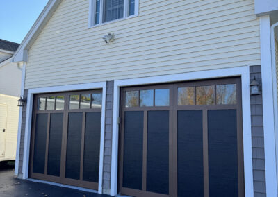 black garage doors with brown trim