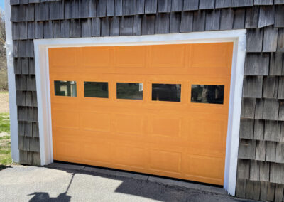orange garage door on shaker house